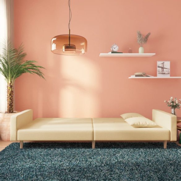 kétszemélyes krémszínű szövet kanapéágy két párnával