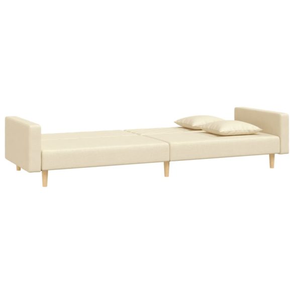 kétszemélyes krémszínű szövet kanapéágy két párnával